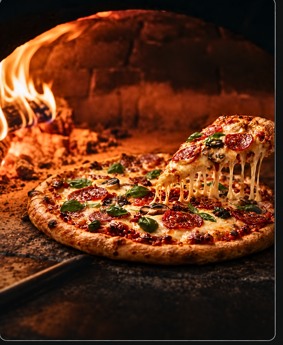 Stone baked Italian pizza with melting cheese and fresh basil inside a blazing hot pizza oven with orange flame reflection.